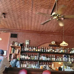 Beautiful wood back bar with tin ceiling