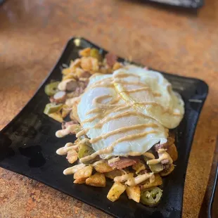 Potatoe scramble with bacon, ham, sausage, potatoes, jalapeños, 3 over easy eggs, and potatoes