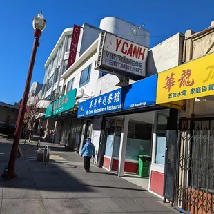 a row of stores along a sidewalk
