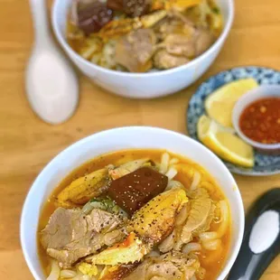 two bowls of soup and a spoon