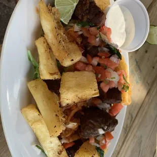a plate of tacos and fries