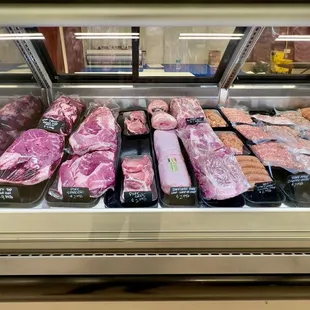 a variety of meat in a display case