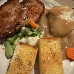 Pork chop with mashed potatoes a d garlic bread