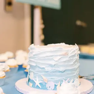 a cake and cupcakes on a table