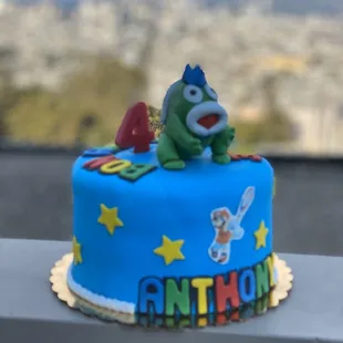 a blue cake with a cartoon character on top