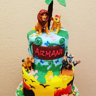 Lion King cake with toys 2 tiered cake.