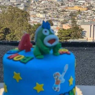 a birthday cake with a view of the city