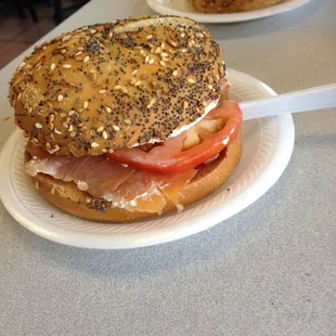 Bagel with lox and cream cheese tomato and onion