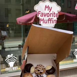 a person holding a box of doughnuts
