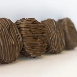 a row of chocolate covered donuts