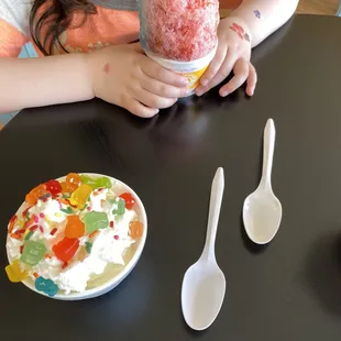 a young girl eating an ice cream sundae