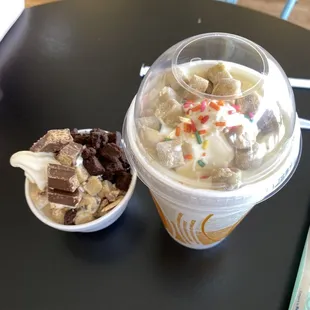 a cup of ice cream with a scoop of chocolate and sprinkles