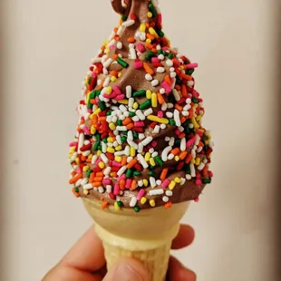an ice cream cone with sprinkles