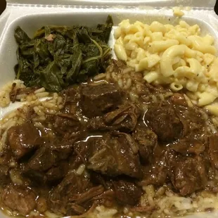 Beef tips and rice with Mac n&apos; cheese and greens as sides. Cost: $11.00