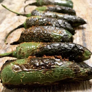 a row of poblao peppers on a cutting board