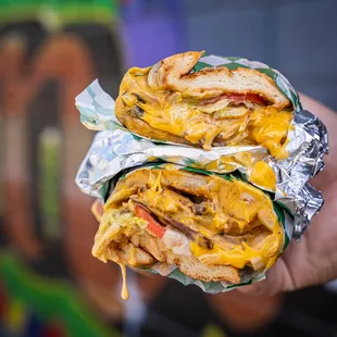 a hand holding a sandwich