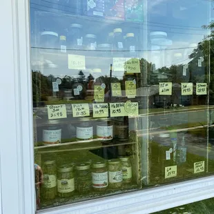 jars of honey in a store window