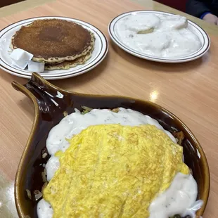 Country Skillet with scrambled eggs  (Chicken Fried Steak pieces with gravy) and pancakes.  In the back is Biscuits and Gravy.