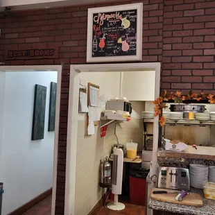 a brick wall with a sign above it