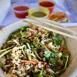 Build your own Bowl with Garlic Rice, Chicken, Bean Sprouts, Carrots &amp; Daikon, Green Onion, Cilantro, Fried Garlic &amp; Sesame Seeds.