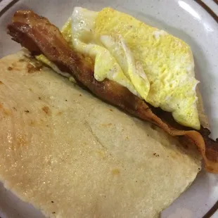 Bacon and egg taco on corn
