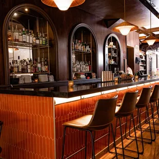 a row of chairs at a bar