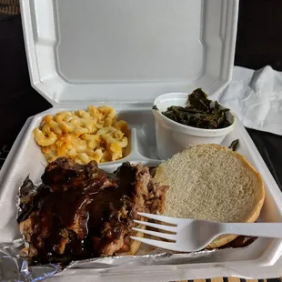 Pulled pork sandwich with collard greens and mac and cheese