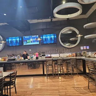 Bar area with tv's also playing music videos.