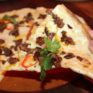 The Open Faced Quesadilla was made with queso trio, caramelized onion, sweet peppers, cilantro crema and flour tortilla. We added on steak.