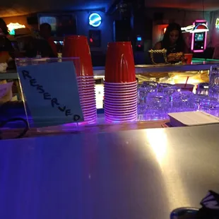 a bar with a lot of cups on the counter