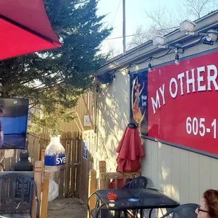 a woman sitting at a table with an umbrella