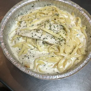 a bowl of pasta in a tin