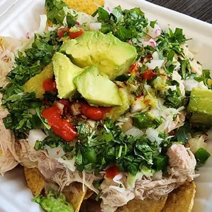 Poznachos with chicken and all toppings, including double avocado.