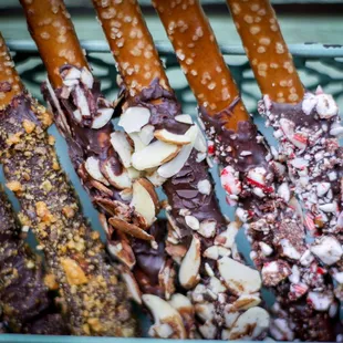 Close up of a few pretzel flavors-Butterfinger Crumble, Shaved Almond, Peppermint Kiss.