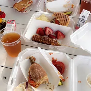 two girls eating sandwiches and fruit