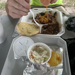 a person putting mustard on a piece of bread