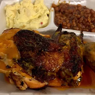 Close up of 1/2 chicken dinner...baked beans and potato salad