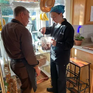 Melissa teaching how to repeatedly blend, scrape and taste to achieve the perfect mousse consistency.