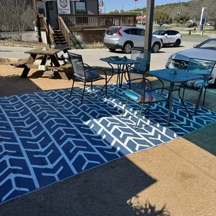 a patio area with a table and chairs