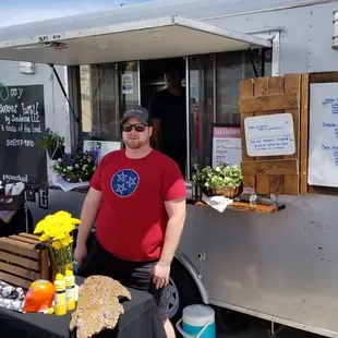 a man standing in front of a food truck