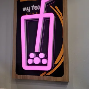 a glass of tea with a straw