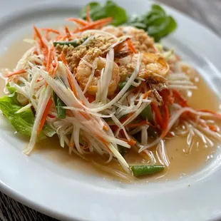 a white plate with a salad on it