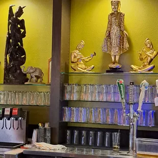 Intricate Thai statuettes inside restaurant