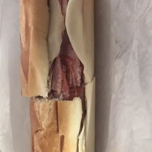 a sub sandwich with meat and cheese