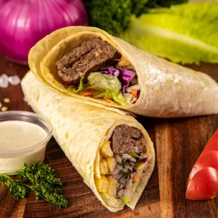 two burritos on a cutting board