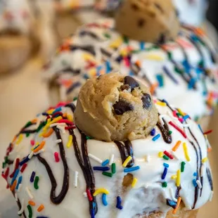 a plate of doughnuts with frosting and sprinkles
