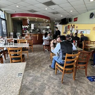  people sitting at tables in a restaurant