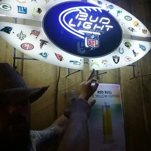 a man holding up a surfboard sign