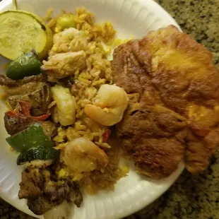 A fried Pork Chop rice with Shrimp a Kabob with zucchini, squash, bell peppers and onion