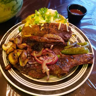Ribeye, Baked potato with grilled onion, bell peppers and mushrooms